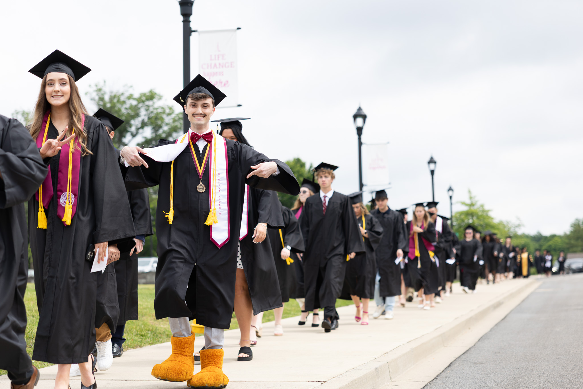 CU Graduate Bryce Osborne takes the graduate’s walk with his classmates and shows off his role as CU mascot Clawz by wearing the recognizable paws CU Graduate Bryce Osborne takes the graduate’s walk with his classmates and shows off his role as CU mascot Clawz by wearing the recognizable paws